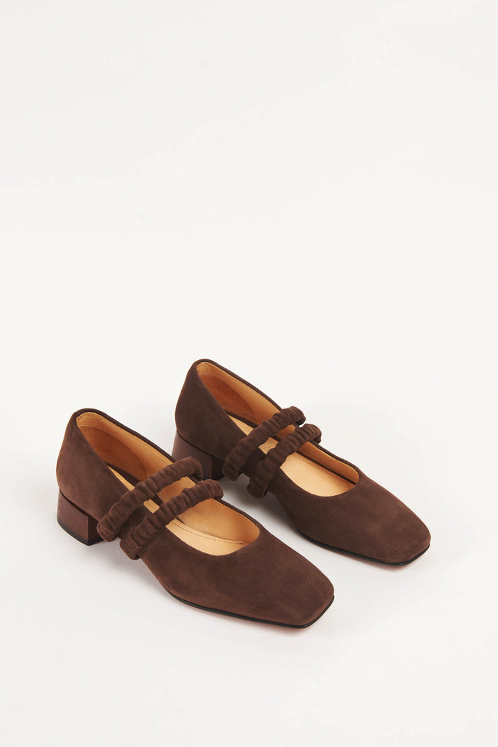 Mid-heel low-heel mary jane pump made from premium dark chocolate brown suede. This shoe features two scrunchy elasticated straps for added support. The lining is made from veg-tan buttery soft leather. The heel is made from wood and sits at a height of 3cm, and has a rubber sole for non-slip wear. Perfect office shoe for women. Day-to-night mary jane shoes for women in sizes EU 36 - 41. Pinterest aesthetic mary jane ballerina shoes.