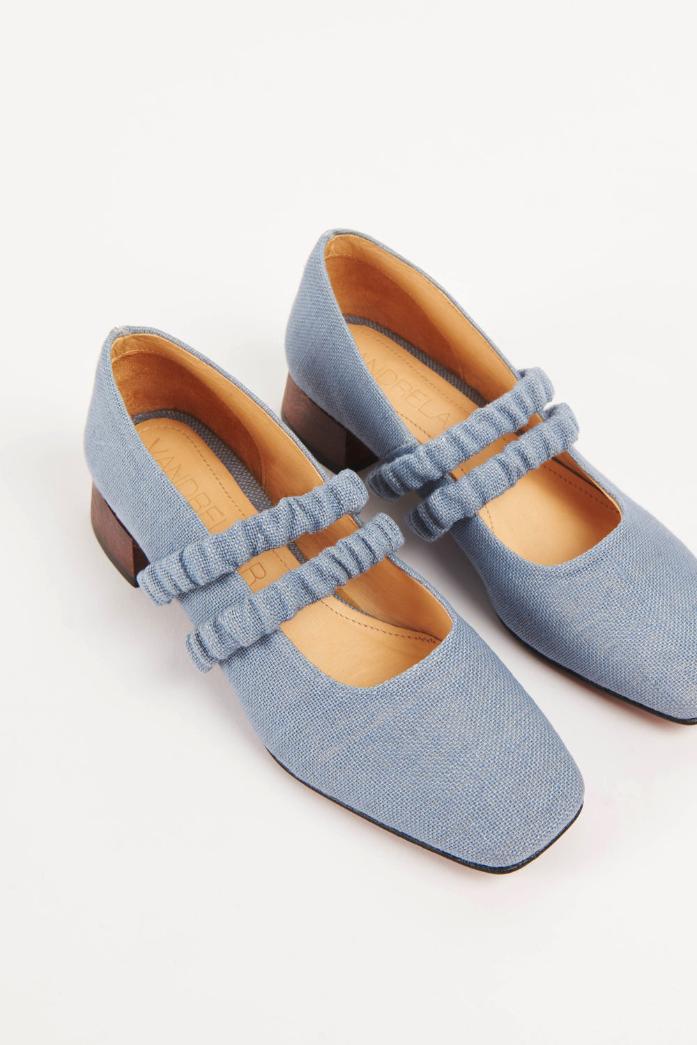 Mid-heel low-heel mary jane pump made from European light powder baby blue linen fabric. This shoe features two scrunchy elasticated straps for added support. The lining is made from veg-tan buttery soft leather. The heel is made from wood and sits at a height of 3cm, and has a rubber sole for non-slip wear. Perfect office shoe for women. Day-to-night mary jane shoes for women in sizes EU 36 - 41. Pinterest aesthetic mary jane ballerina shoes.