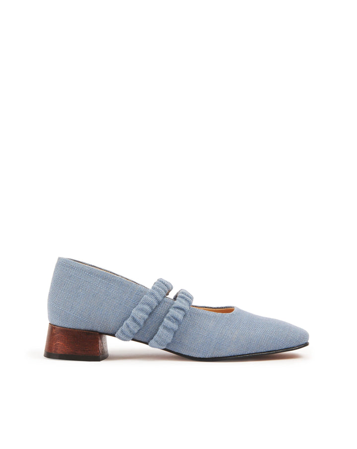 Mid-heel low-heel mary jane pump made from European light powder baby blue linen fabric. This shoe features two scrunchy elasticated straps for added support. The lining is made from veg-tan buttery soft leather. The heel is made from wood and sits at a height of 3cm, and has a rubber sole for non-slip wear. Perfect office shoe for women. Day-to-night mary jane shoes for women in sizes EU 36 - 41. Pinterest aesthetic mary jane ballerina shoes.