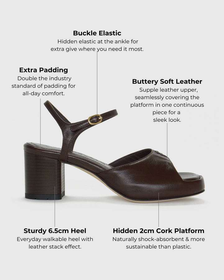 Women's mid-heel block heel open toe sandal with a concealed hidden platform of 2cm (3/4 inch) height and a stacked effect sturdy block heel of 6.5cm (2 3/4 inch) height. The elegant, minimal and timeless sandals comes with a dainty ankle strap that is elasticated to provide additional comfort. The insole is cut to a square toe shape and is fully padded for ultimate all-day comfort. This is the perfect 90's inspired cool girl sandal to wear all spring summer! Made from premium shiny espresso brown leather.