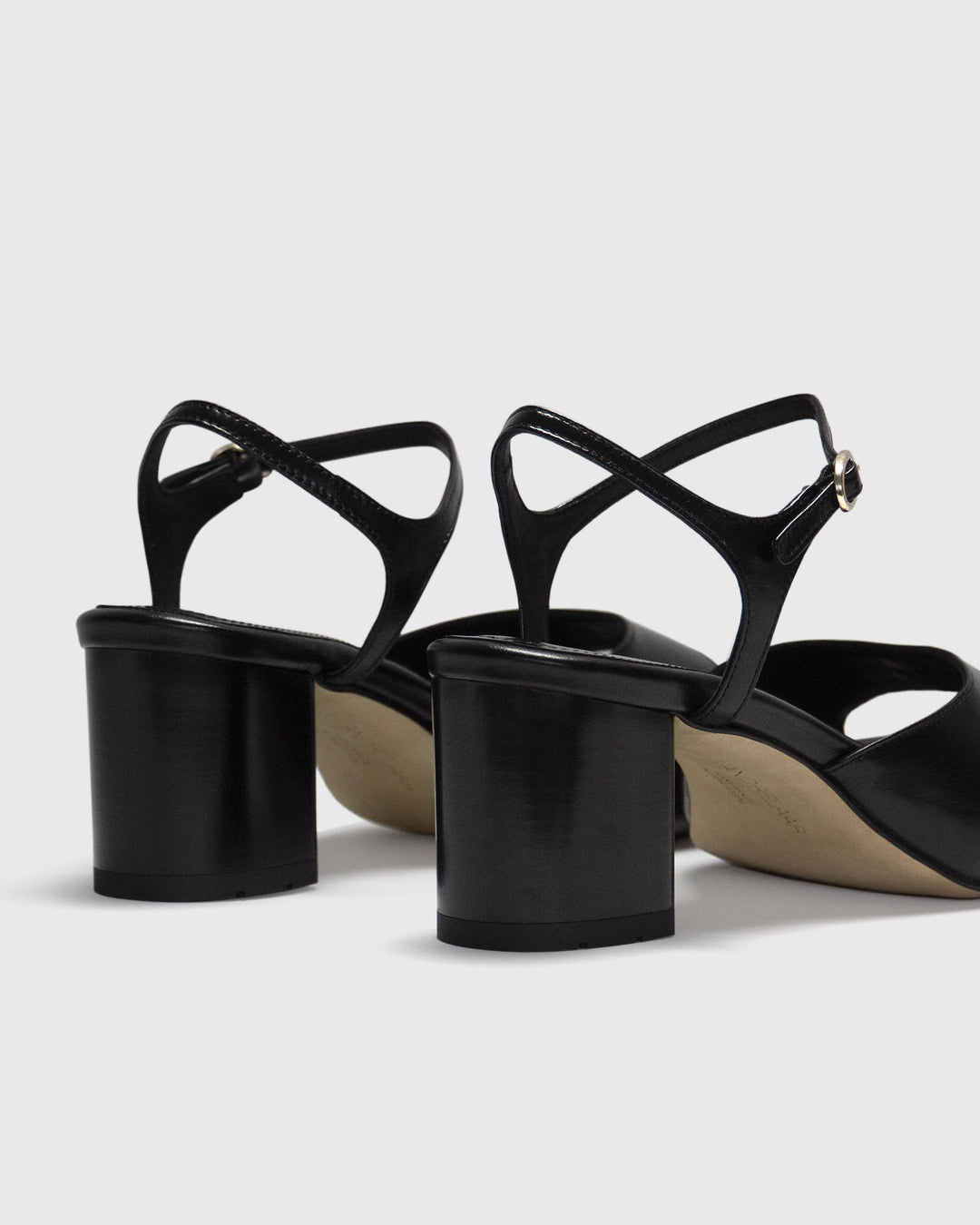 Women's mid-heel block heel open toe sandal with a concealed hidden platform of 2cm (3/4 inch) height and a stacked effect sturdy block heel of 6.5cm (2 3/4 inch) height. The elegant, minimal and timeless sandals comes with a dainty ankle strap that is elasticated to provide additional comfort. The insole is cut to a square toe shape and is fully padded for ultimate all-day comfort. This is the perfect 90's inspired cool girl sandal to wear all spring summer! Made from premium shiny black leather.